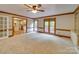 Open living room featuring plush carpet, built-in shelves, and views of kitchen with an island at 5412 Crosshill Ct, Charlotte, NC 28277
