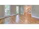 Bright living room featuring hardwood floors, large windows, and neutral wall colors at 5412 Crosshill Ct, Charlotte, NC 28277