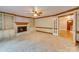 Spacious living room with fireplace, built-in bookshelves, plush carpeting and large windows at 5412 Crosshill Ct, Charlotte, NC 28277