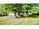 Spacious backyard featuring a wooden balcony and surrounded by lush green trees at 5520 Chestnut Dr, Hickory, NC 28602