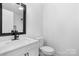 This bright bathroom has a quartz vanity, tile backsplash, and updated fixtures at 5520 Chestnut Dr, Hickory, NC 28602