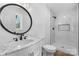 Modern bathroom with marble sink, decorative mirror, and glass enclosed shower at 5520 Chestnut Dr, Hickory, NC 28602