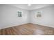 This bedroom features hardwood floors and dual windows offering ample natural light at 5520 Chestnut Dr, Hickory, NC 28602