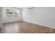 This bedroom boasts hardwood floors, a mini-split system, and a window with neighborhood views at 5520 Chestnut Dr, Hickory, NC 28602