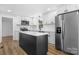 Modern kitchen featuring white cabinets, stainless steel appliances, and a center island at 5520 Chestnut Dr, Hickory, NC 28602