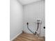 Laundry room with brick accent wall, washer/dryer hookups and wood flooring at 5520 Chestnut Dr, Hickory, NC 28602