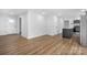 Open-concept living space featuring luxury vinyl flooring, white walls, and natural light at 5520 Chestnut Dr, Hickory, NC 28602