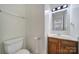 Bathroom featuring a wooden vanity, toilet and a large mirror at 5524 Wyalong Dr, Charlotte, NC 28227
