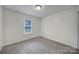Bedroom featuring neutral walls, plush carpet, and a light filled window at 5524 Wyalong Dr, Charlotte, NC 28227