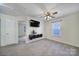 Bedroom featuring neutral walls, plush carpet, a ceiling fan, and mounted television set at 5524 Wyalong Dr, Charlotte, NC 28227