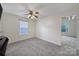 Bedroom featuring neutral walls, plush carpet, and a ceiling fan at 5524 Wyalong Dr, Charlotte, NC 28227