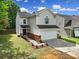 Two-story home featuring a two-car garage, lovely landscaping, and a welcoming front entrance at 5524 Wyalong Dr, Charlotte, NC 28227