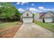 Charming home with a two-car garage, lush lawn, brick accents, and inviting curb appeal at 5524 Wyalong Dr, Charlotte, NC 28227