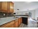 Well-equipped kitchen with granite countertops, mosaic backsplash, wooden cabinets and stainless steel appliances at 5524 Wyalong Dr, Charlotte, NC 28227