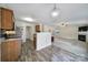 Open layout showing a well-lit kitchen and living room, with granite countertops and cozy fireplace at 5524 Wyalong Dr, Charlotte, NC 28227