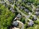 Aerial view of a neighborhood featuring lush greenery, well-maintained homes, and tree-lined streets in a residential area at 5809 Woodleigh Oaks Dr, Charlotte, NC 28226