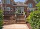 Backyard with stairs leading to a deck, framed by lush landscaping at 5809 Woodleigh Oaks Dr, Charlotte, NC 28226