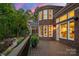 Expansive backyard deck overlooking a meticulously landscaped yard, attached to a brick home with large windows at 5809 Woodleigh Oaks Dr, Charlotte, NC 28226