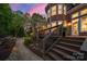 Stunning backyard deck leading to a brick house featuring beautiful landscaping and a fire pit area at 5809 Woodleigh Oaks Dr, Charlotte, NC 28226