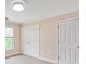 Carpeted bedroom with pink walls and double door closets at 5809 Woodleigh Oaks Dr, Charlotte, NC 28226