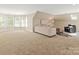 Large bonus room with a comfortable seating area and lots of natural light at 5809 Woodleigh Oaks Dr, Charlotte, NC 28226