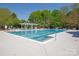 Community pool surrounded by lounge chairs and shaded seating areas, perfect for relaxing and enjoying the outdoors at 5809 Woodleigh Oaks Dr, Charlotte, NC 28226