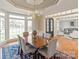 Open-concept dining room with views of the living spaces and large windows at 5809 Woodleigh Oaks Dr, Charlotte, NC 28226