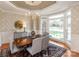 Dining room with natural light, neutral colors, and traditional décor with an elegant chandelier at 5809 Woodleigh Oaks Dr, Charlotte, NC 28226