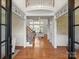Grand foyer with hardwood floors, soaring ceilings, and a view of the staircase and living room at 5809 Woodleigh Oaks Dr, Charlotte, NC 28226