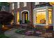 Charming front entrance with a brick walkway, manicured garden, and inviting doorway at 5809 Woodleigh Oaks Dr, Charlotte, NC 28226
