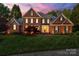 Elegant brick home with a manicured lawn and beautiful landscaping, exuding curb appeal at 5809 Woodleigh Oaks Dr, Charlotte, NC 28226