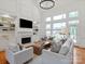 Bright living room with a fireplace, custom built-ins, and comfortable seating for relaxation at 5809 Woodleigh Oaks Dr, Charlotte, NC 28226