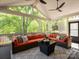 Relaxing screened-in sunroom with comfortable seating and views of the trees at 5809 Woodleigh Oaks Dr, Charlotte, NC 28226