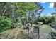 Secluded backyard featuring a stone patio, lush landscaping, and a private seating area at 656 Hosta Dr, Fort Mill, SC 29715