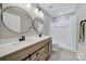 Bathroom featuring a double vanity, round mirrors and tiled shower at 656 Hosta Dr, Fort Mill, SC 29715