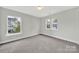 Bright and airy bedroom featuring neutral walls, large windows, and cozy carpet at 656 Hosta Dr, Fort Mill, SC 29715