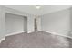 Neutral bedroom featuring plush carpeting, a closet, and a light fixture at 656 Hosta Dr, Fort Mill, SC 29715