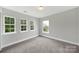 Bright bedroom with three windows offering natural light and outdoor views at 656 Hosta Dr, Fort Mill, SC 29715