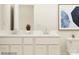 Modern bathroom vanity with double sinks, neutral countertop, and a large mirror offering bright, elegant space at 671 Mile Creek Rd, Edgemoor, SC 29712