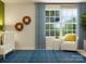 Bright Bedroom with blue accents, large window, comfortable chair, and stylish lion themed wall decor at 671 Mile Creek Rd, Edgemoor, SC 29712