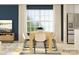 Dining room featuring a wooden table, modern chairs, and a large window with natural light at 671 Mile Creek Rd, Edgemoor, SC 29712
