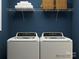 Convenient laundry room with modern washer and dryer, with a rack and decorative baskets above at 671 Mile Creek Rd, Edgemoor, SC 29712