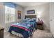 Themed bedroom with comfortable bed, playful decor, and ample natural light from a large window at 1813 Millstream Dr, China Grove, NC 28023