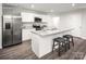Modern kitchen featuring stainless steel appliances, white cabinets, granite countertops, and breakfast bar with seating at 1813 Millstream Dr, China Grove, NC 28023