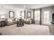 Spacious living room with neutral decor, plush carpeting, ample natural light, and access to outdoor balcony at 1813 Millstream Dr, China Grove, NC 28023