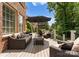 Relax on this cozy back deck featuring cushioned seating and shaded umbrellas for outdoor enjoyment at 7005 Camrose Crossing Ln, Matthews, NC 28104