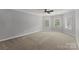 Spacious bedroom with neutral carpet, a ceiling fan, and ample windows at 7005 Camrose Crossing Ln, Matthews, NC 28104
