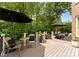 Inviting outdoor deck featuring comfortable seating, accent tables, and lush green surroundings at 7005 Camrose Crossing Ln, Matthews, NC 28104