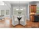 The dining area features a glass table with white chairs and natural lighting at 7005 Camrose Crossing Ln, Matthews, NC 28104