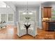 Dining nook features hardwood floors, natural light, and comfortable seating for four at 7005 Camrose Crossing Ln, Matthews, NC 28104